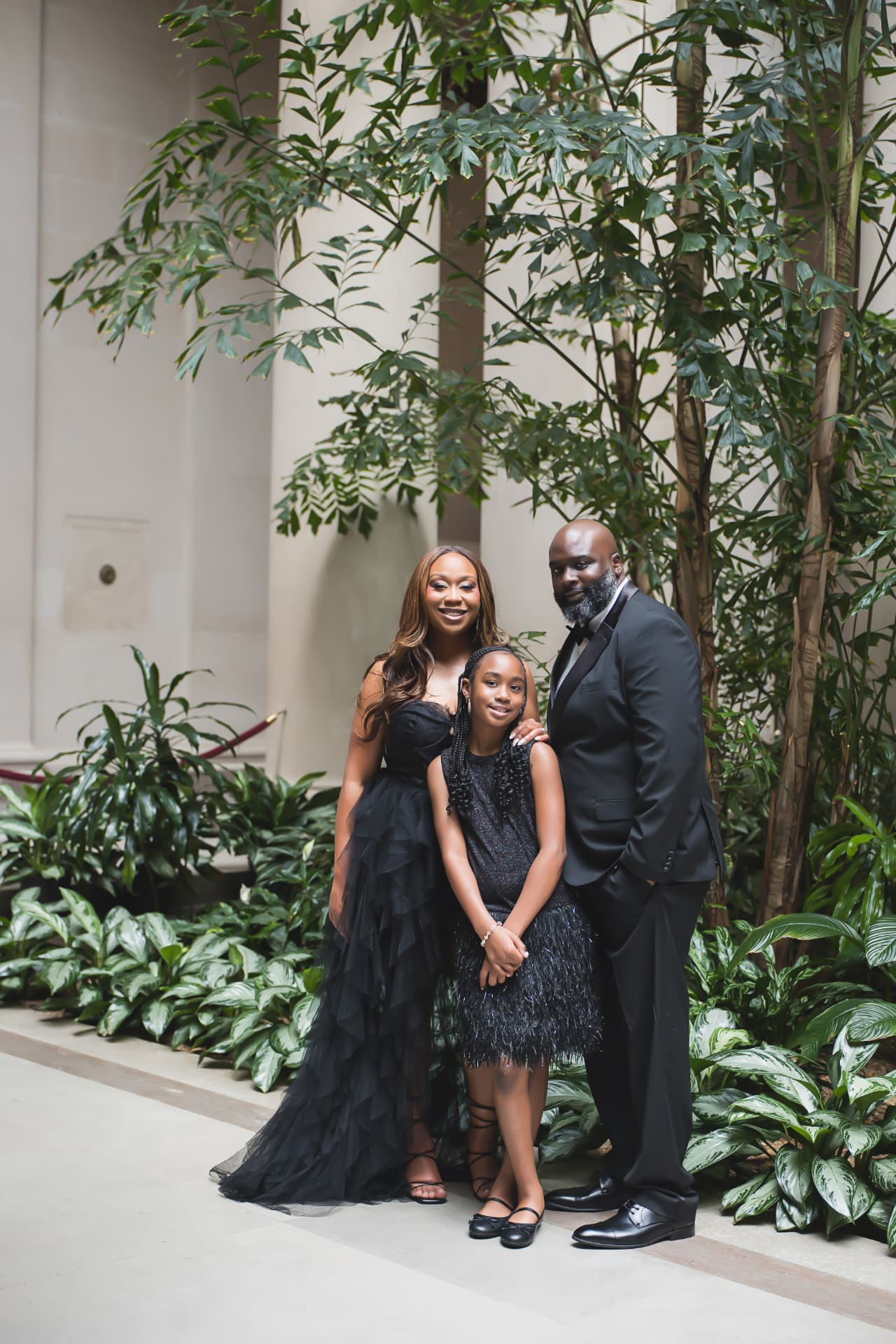 Jarron, Marissa, and their daughter Madison in black formal attire